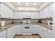 Bright kitchen featuring white cabinetry and modern appliances at 1532 Pelican Point Dr # 240, Sarasota, FL 34231