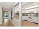 Bright kitchen featuring white cabinetry, stainless steel sink, and modern appliances at 1532 Pelican Point Dr # 240, Sarasota, FL 34231