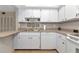 Bright kitchen featuring white cabinetry, stainless steel sink, and modern appliances at 1532 Pelican Point Dr # 240, Sarasota, FL 34231