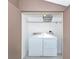 Efficient laundry space with a modern washer and dryer set, shelf and ample storage, making chores a breeze at 1532 Pelican Point Dr # 240, Sarasota, FL 34231