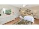 Comfortable bedroom with hardwood floors, neutral decor, and ample natural light at 1532 Pelican Point Dr # 240, Sarasota, FL 34231