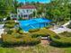 Beautiful estate featuring a pool and outdoor lounge with carefully manicured lawns and gardens at 1532 Pelican Point Dr # 240, Sarasota, FL 34231