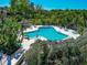 A luxurious community pool surrounded by lush landscaping, providing a serene and inviting outdoor experience at 1532 Pelican Point Dr # 240, Sarasota, FL 34231
