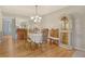 Elegant dining room featuring hardwood floors, a mirrored wall, and a stylish chandelier at 1532 Pelican Point Dr # Ba139, Sarasota, FL 34231