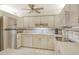 Bright kitchen offering white appliances, tile flooring, and lots of cabinet space for storage at 1532 Pelican Point Dr # Ba139, Sarasota, FL 34231