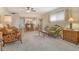 Spacious living room featuring classic furniture pieces, plush carpeting, and a ceiling fan at 1532 Pelican Point Dr # Ba139, Sarasota, FL 34231