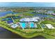 Resort-style community showcasing a pool, clubhouse, tennis courts, basketball court, and pristine landscaping near a lake at 15503 Sunny Day Dr, Bradenton, FL 34211