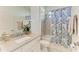 Bathroom featuring granite countertop, white cabinets, and shower with tub at 15503 Sunny Day Dr, Bradenton, FL 34211