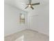 Bedroom featuring tiled floors, ceiling fan, window, and closet at 15503 Sunny Day Dr, Bradenton, FL 34211