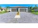 Beautiful two-car garage with paved driveway and meticulously landscaped front yard at 15503 Sunny Day Dr, Bradenton, FL 34211