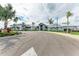 Exterior view of community center with beautiful tropical landscaping and ample parking at 15503 Sunny Day Dr, Bradenton, FL 34211
