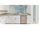 Kitchen features granite countertops, stainless steel dishwasher, and bright lighting at 15503 Sunny Day Dr, Bradenton, FL 34211