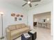 Cozy living room with tile floors, a couch and view to dining room at 15503 Sunny Day Dr, Bradenton, FL 34211