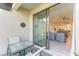 Relaxing outdoor patio with glass-top table and comfortable seating, seamlessly connecting to the inviting living area at 15503 Sunny Day Dr, Bradenton, FL 34211