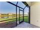 Screened patio providing views of the lake and landscaping at 15503 Sunny Day Dr, Bradenton, FL 34211