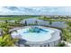 Aerial shot of a splash pad with playful features and a scenic lake backdrop at 15503 Sunny Day Dr, Bradenton, FL 34211