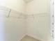 Walk-in closet offering wire shelving and tiled floors at 15503 Sunny Day Dr, Bradenton, FL 34211