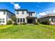 A beautiful backyard featuring a well-maintained lawn, and a covered patio for outdoor enjoyment at 16134 Paynes Mill Dr, Bradenton, FL 34211