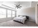 This bedroom features a large ceiling fan, neutral colors, and large windows for tons of natural light at 16134 Paynes Mill Dr, Bradenton, FL 34211