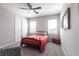 This bedroom features neutral colors, a ceiling fan, large windows, and wood furniture at 16134 Paynes Mill Dr, Bradenton, FL 34211