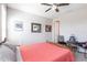 This bedroom features neutral colors, a ceiling fan, and framed pictures on the wall at 16134 Paynes Mill Dr, Bradenton, FL 34211