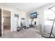 Well-lit exercise room featuring mirrors, a TV, and exercise equipment for a convenient at-home workout experience at 16134 Paynes Mill Dr, Bradenton, FL 34211