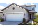 Charming two-story home featuring a pristine white garage door and a neatly landscaped yard at 16134 Paynes Mill Dr, Bradenton, FL 34211