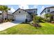 Inviting two-story home with lush green lawn and tidy landscaping at 16134 Paynes Mill Dr, Bradenton, FL 34211