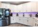 Bright kitchen with white cabinets, quartz countertops, and stainless steel appliances at 16134 Paynes Mill Dr, Bradenton, FL 34211