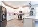 Modern white kitchen featuring stainless steel appliances and ample counter space at 16134 Paynes Mill Dr, Bradenton, FL 34211