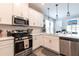 Modern kitchen with stainless steel appliances and a breakfast bar at 16134 Paynes Mill Dr, Bradenton, FL 34211