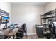 Home office featuring two desks with black leather chairs, storage shelves and a mounted monitor at 16134 Paynes Mill Dr, Bradenton, FL 34211