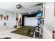 Recreation room has a golf simulator, two TVs, decorations, and faux brick accent wall at 16134 Paynes Mill Dr, Bradenton, FL 34211