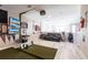 Recreation room with a golf simulator, lounge area with black sofa, and view to the loft at 16134 Paynes Mill Dr, Bradenton, FL 34211
