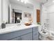 Bright bathroom with a large mirror, double vanity, and a bathtub with shower and gray accents at 16622 San Nicola Pl, Bradenton, FL 34211