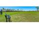 A large, open dog park with lush green grass and a bench, perfect for pet owners to enjoy at 16622 San Nicola Pl, Bradenton, FL 34211