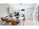 Bright kitchen with white cabinets, modern appliances, and a breakfast bar at 16622 San Nicola Pl, Bradenton, FL 34211