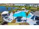 Elevated view of a resort-style pool with lush landscaping, lounge seating, and a clear blue sky at 16622 San Nicola Pl, Bradenton, FL 34211