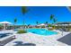 Resort-style pool surrounded by lounge chairs, palm trees, cabanas, and a clear blue sky at 16622 San Nicola Pl, Bradenton, FL 34211