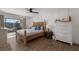 Bright and airy bedroom with wood-look floors, neutral walls, and sliding door out to a balcony at 1714 69Th W Ave # C402, Bradenton, FL 34207
