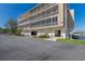 Wide angle shot of a waterfront condo with a parking garage and green spaces on a clear day at 1714 69Th W Ave # C402, Bradenton, FL 34207