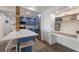 Updated eat-in kitchen featuring a blue island, stainless steel appliances, and a built-in desk/shelving unit at 1714 69Th W Ave # C402, Bradenton, FL 34207