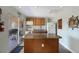Cozy kitchen with an island, wood cabinets, and a sliding door to the outdoor patio at 1714 69Th W Ave # C402, Bradenton, FL 34207