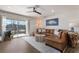 Living room with wood-look floors, comfortable seating, decor and balcony with views at 1714 69Th W Ave # C402, Bradenton, FL 34207