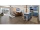 Open-concept living room and kitchen area with luxury vinyl plank flooring and a sliding glass door to a balcony at 1714 69Th W Ave # C402, Bradenton, FL 34207