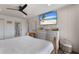 Comfortable main bedroom with wood-look flooring, paneled walls, and bright natural light at 1714 69Th W Ave # C402, Bradenton, FL 34207