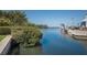 Waterfront view showing boats, boat slips, and lush mangroves along the water at 1714 69Th W Ave # C402, Bradenton, FL 34207