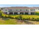 Townhome backyards feature screen patios with green grass at 17620 Crescent Moon Loop, Bradenton, FL 34211