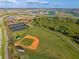 Aerial view of a well-maintained baseball field with walking path and other recreational facilities at 17620 Crescent Moon Loop, Bradenton, FL 34211