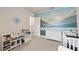 Bedroom with blue and grey mountain mural, white dresser, and white baby crib at 17620 Crescent Moon Loop, Bradenton, FL 34211